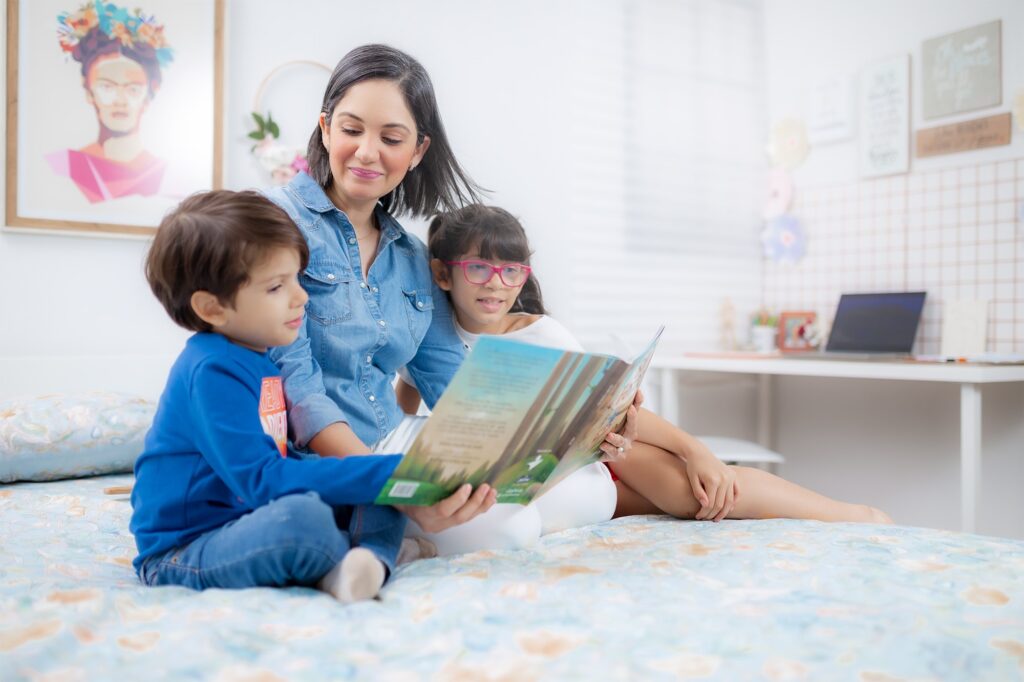 Claudia reading a book to her children